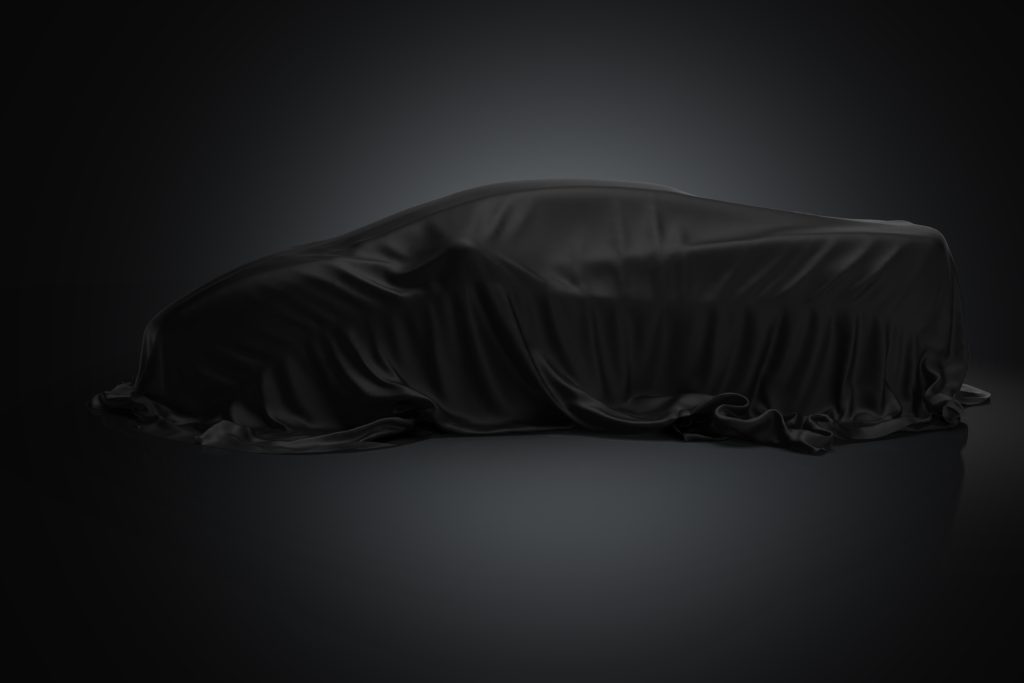3d black color fabric, covered sport car on black background, new car presentation stock photo